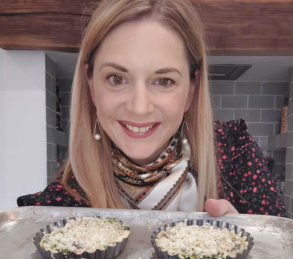 Katie Evans holding a tray of freshly baked tarts