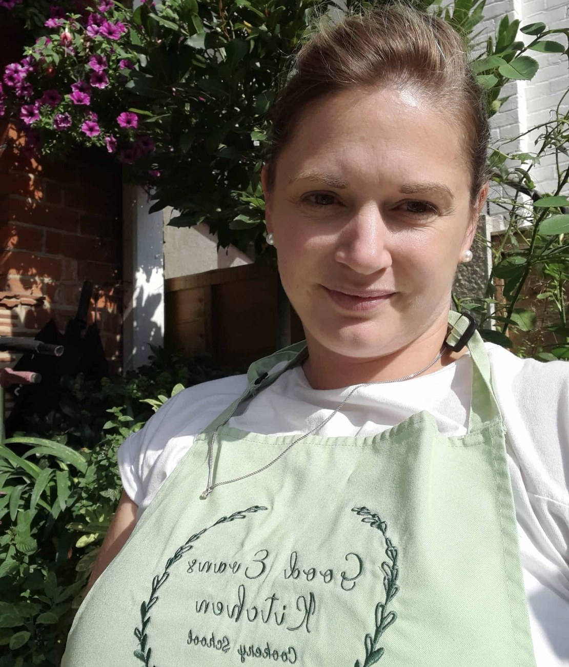 Katie Evans smiling in her Good Evans Kitchen apron